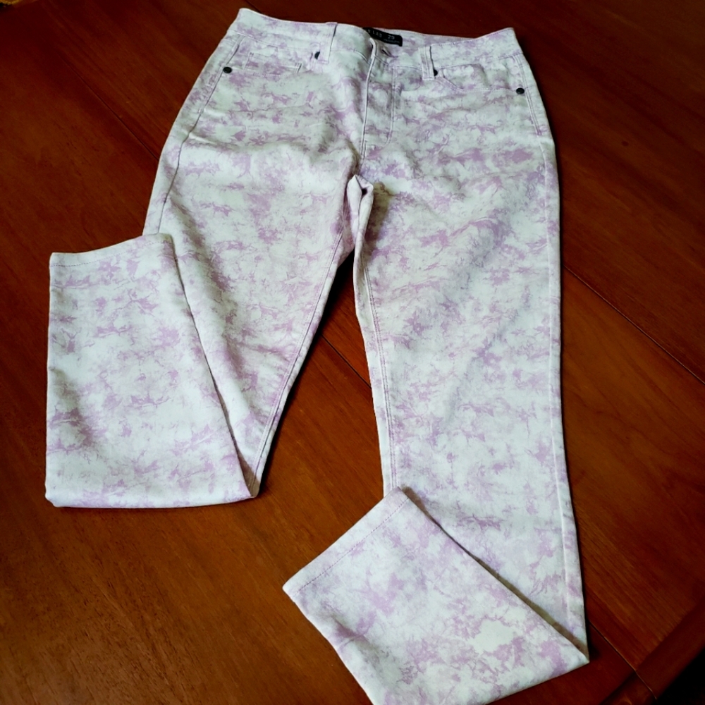 Jeans in a white and lavender tie-dye pattern.